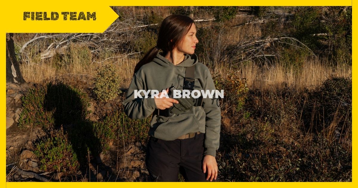 Woman with a recon chest holster standing in the outdoors