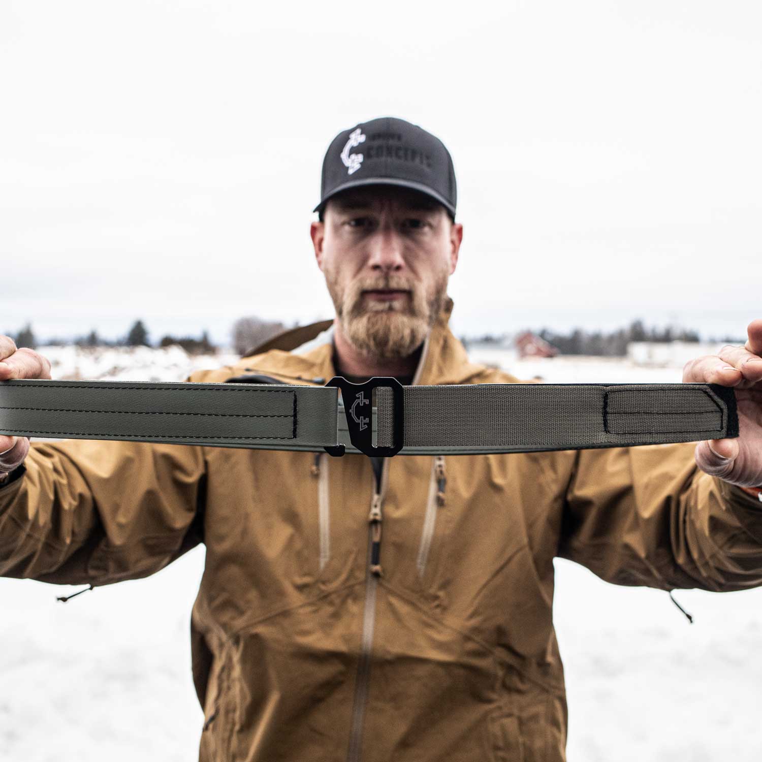 Man holding an od green edc(everyday carry) belt