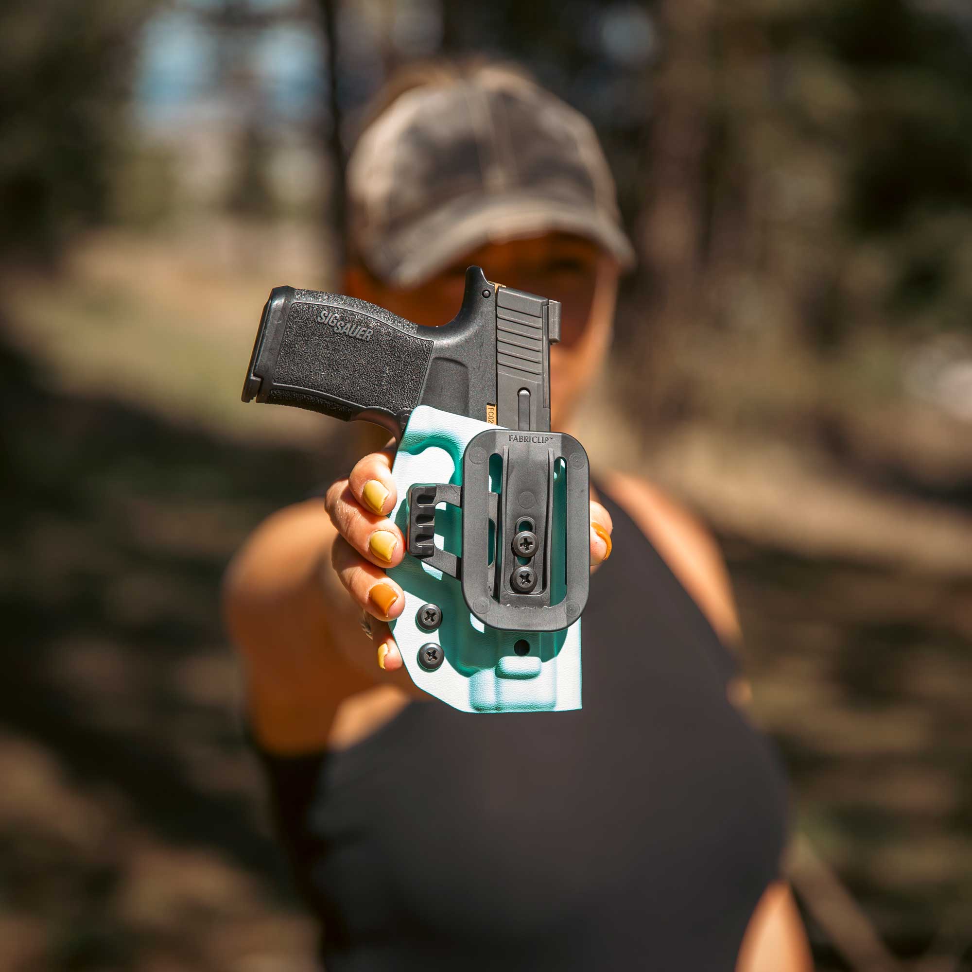 woman holding a fab clip holster for inside the waistband concealed carry