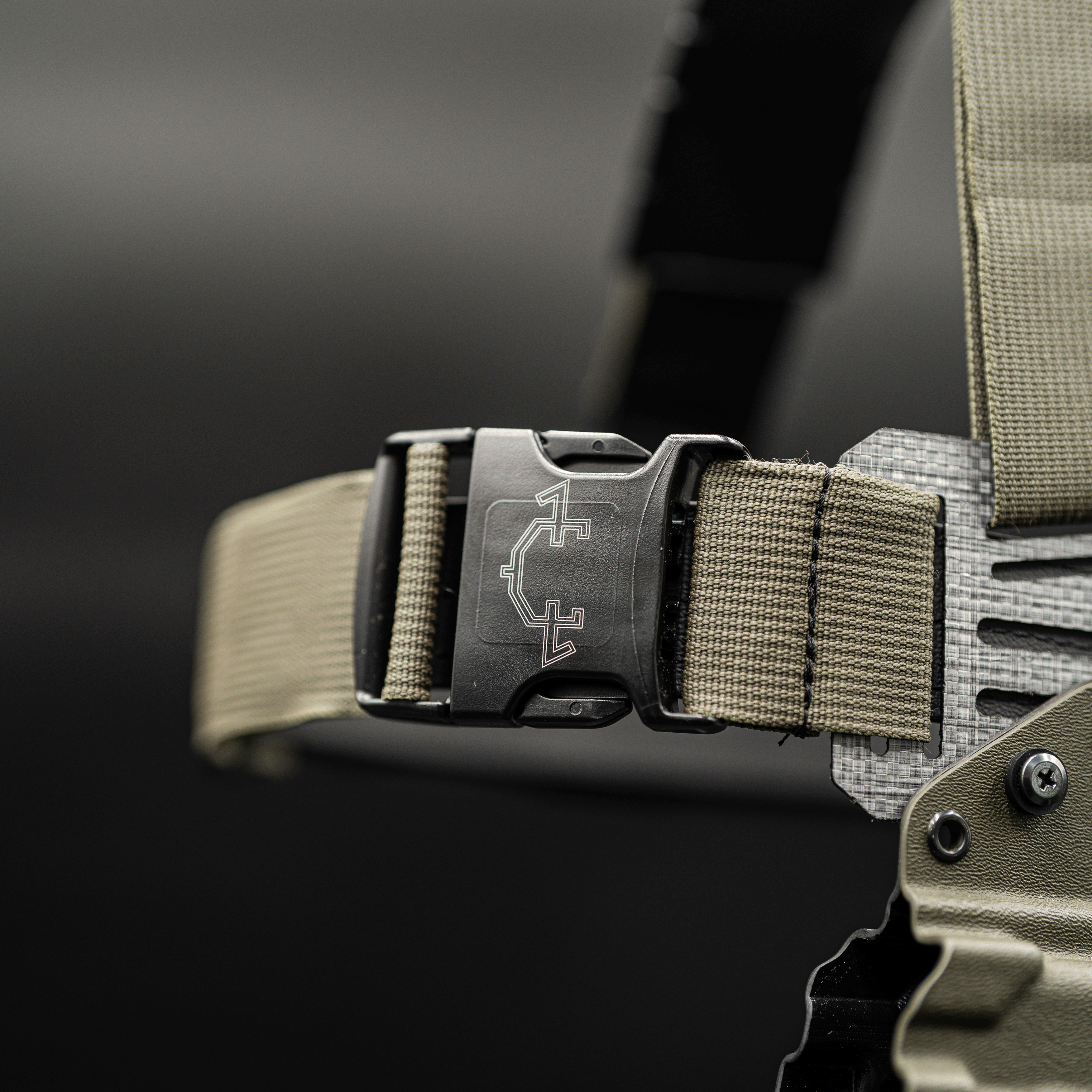 Close-up of a strap buckle on a dark background for the guide torso holter
