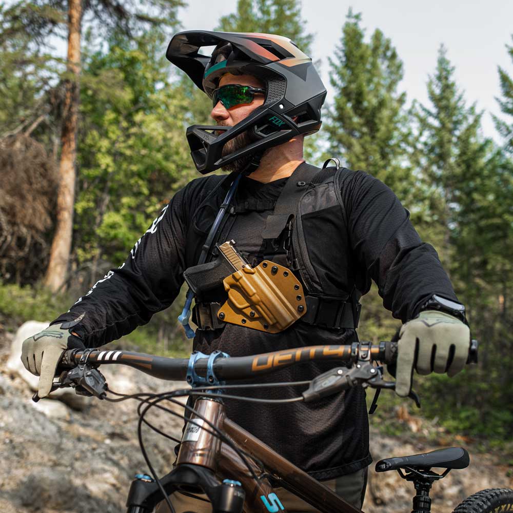 Man in mountain biking gear, wearing a recon chest holster