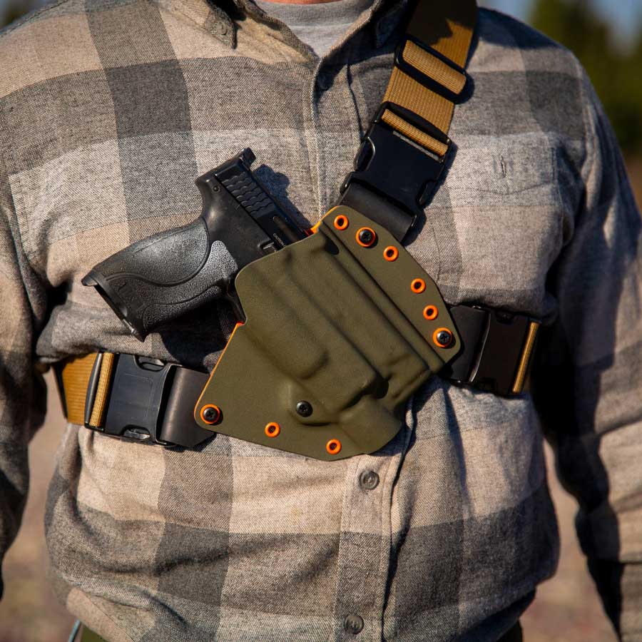 Man wearing a recon chest holster with light options