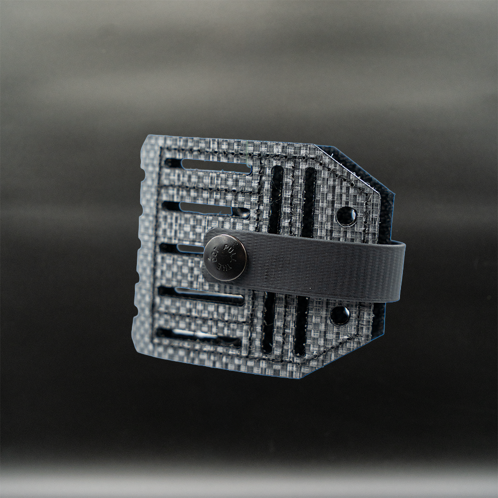 tegris panel blade lok knife attachment on a dark background