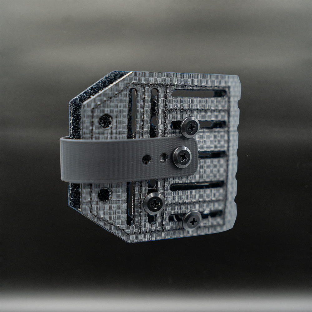 tegris panel blade lok knife attachment on a dark background