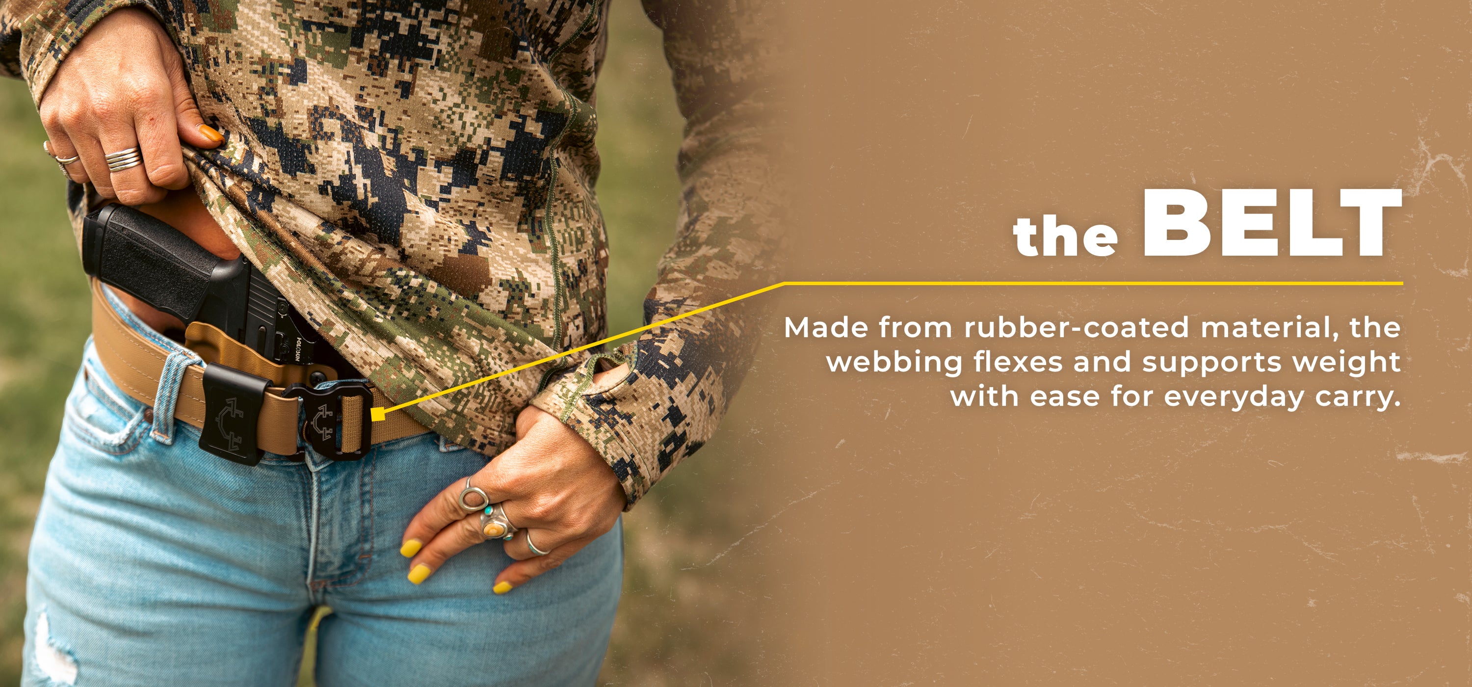 Person wearing a camouflage jacket and blue jeans with a belt, set against a natural background wearing an Invader Concepts Ladies Belt