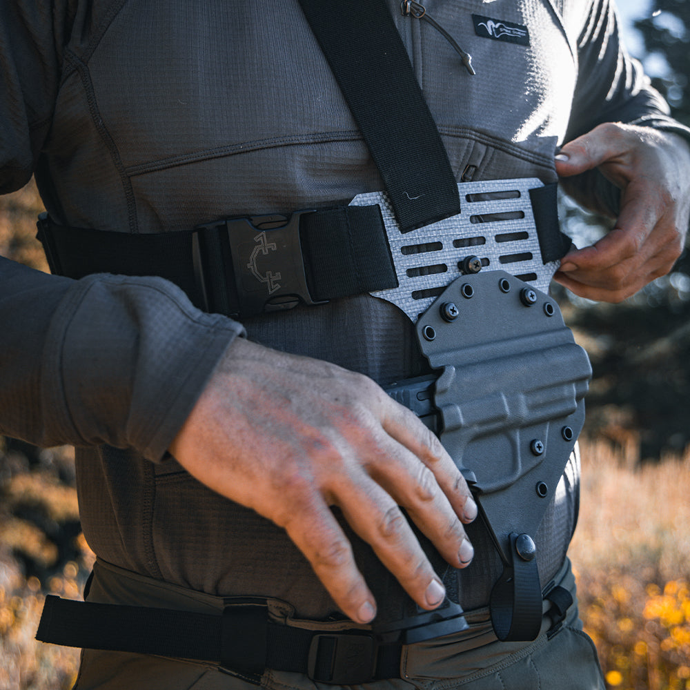 A person putting on a Guide Torso holster