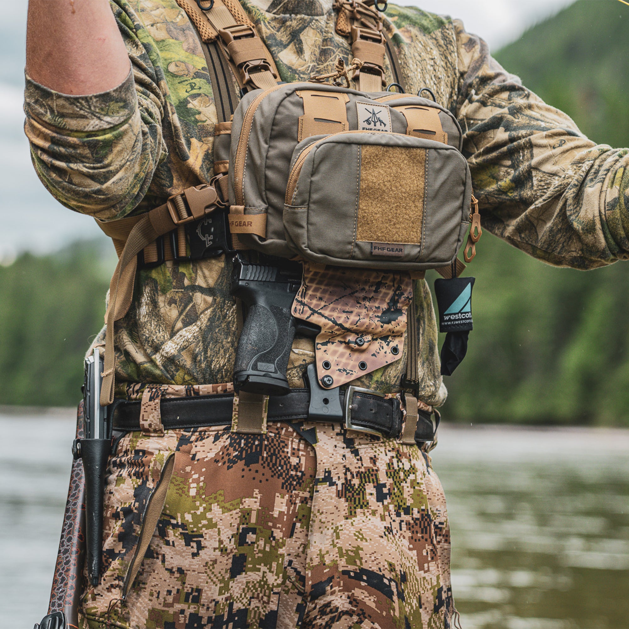 A person fly fishing in the river, while wearing a FHF chest bag, on top of a Guide torso Holster.