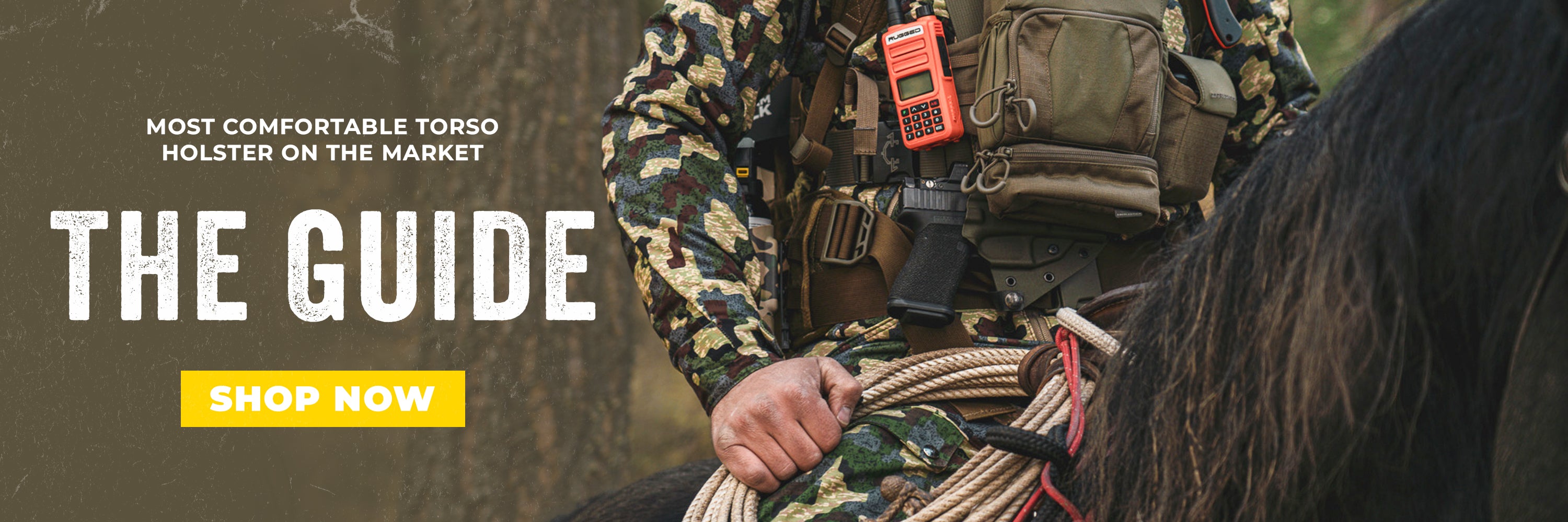 Backcountry hunter wearing an Invader Concepts Guide torso holster for pistol carry while hunting in rugged terrain.