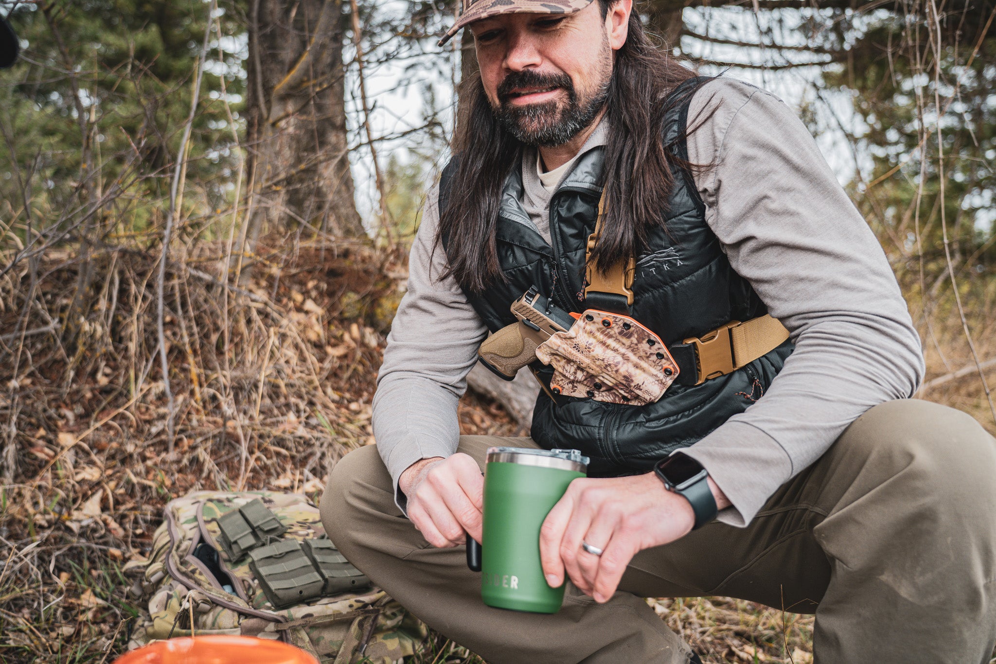 Man wearing a Recon chest holster from Invader Concepts in the backcountry