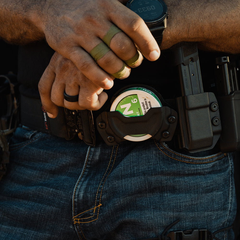 Person wearing a pouch holster attached to an edc(everyday carry) belt